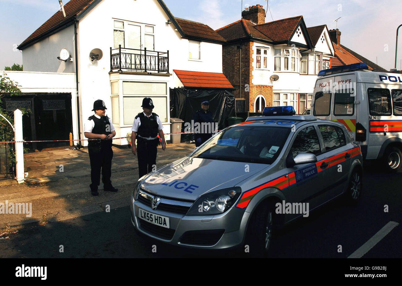 A team of police officers stand outside a house in Sudbury Avenue
