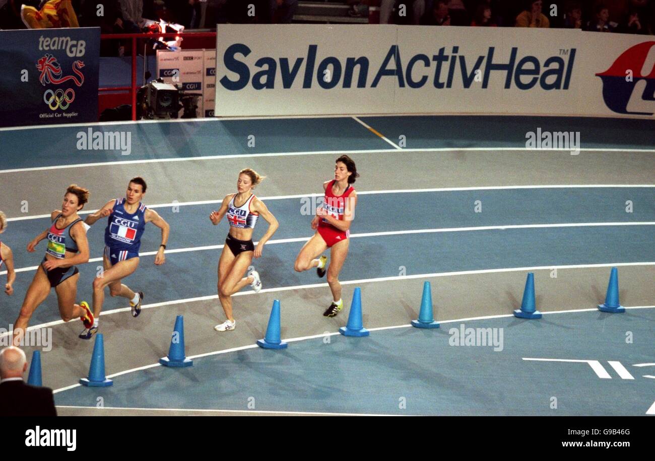 Athletics - CGU Five Nations International Match - Kelvin Hall, Glasgow. Athletes sprint away from a Savlon advertising board Stock Photo