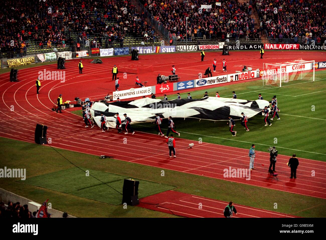 Soccer - UEFA Champions League - Group C - Bayern Munich v Real Madrid. The ball boys remove the giant Champions league logo from the centre of the pitch before the match Stock Photo