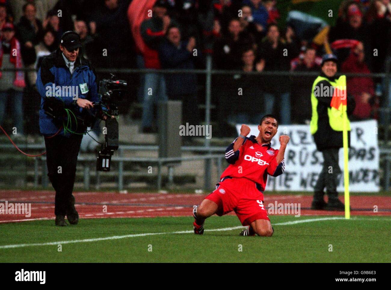 A television cameraman films Bayern Munich's Giovane Elber as he celebrates scoring their second goal Stock Photo