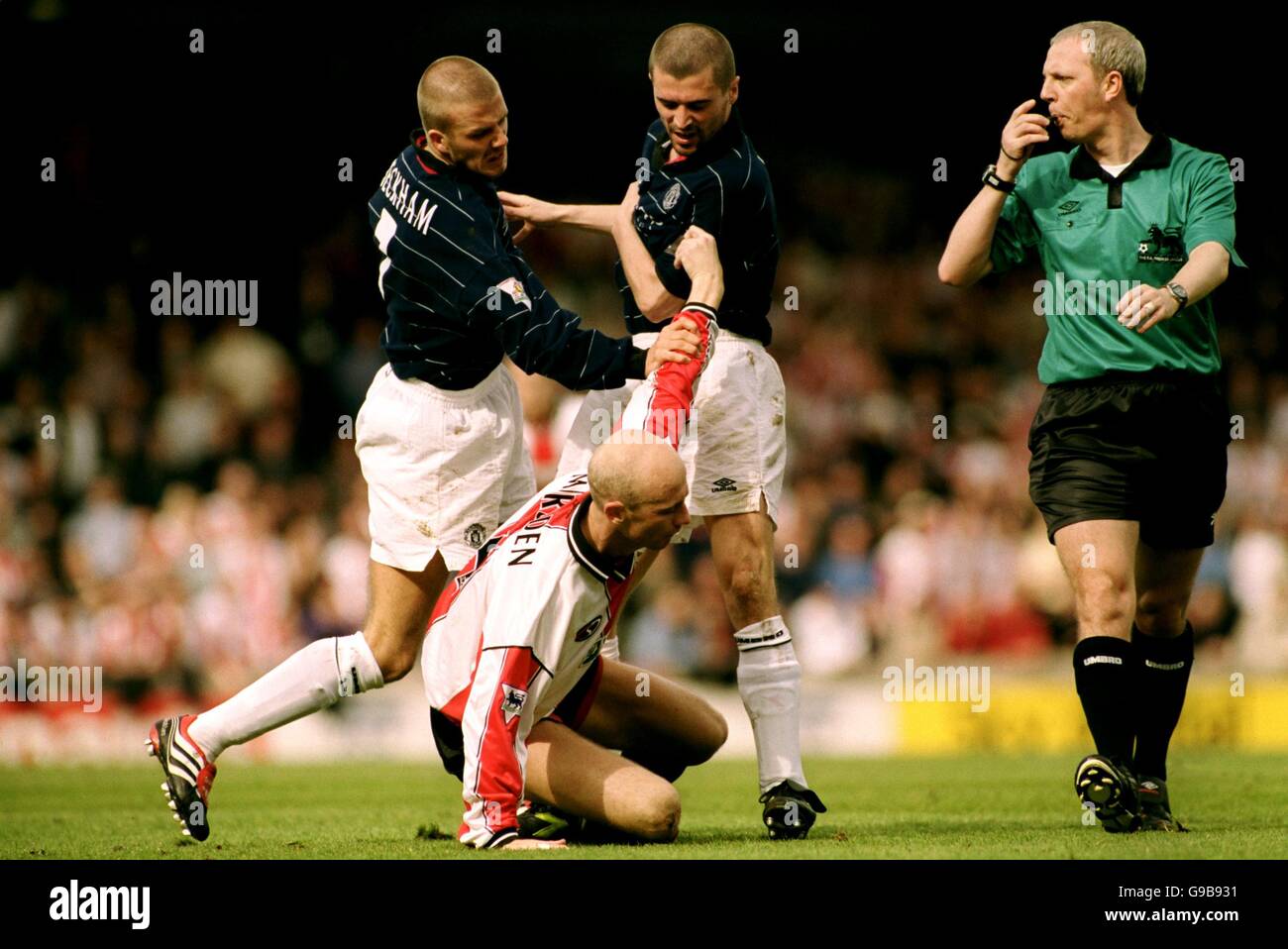 Manchester United's hardmen Roy Keane and David Beckham tussle with Southampton's Chris Marsden Stock Photo