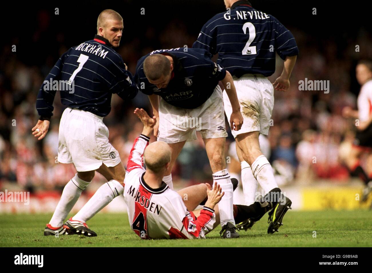 Southampton's Chris Marsden holds off Manchester United's captain Roy Keane after Marsden fouled David Beckham Stock Photo
