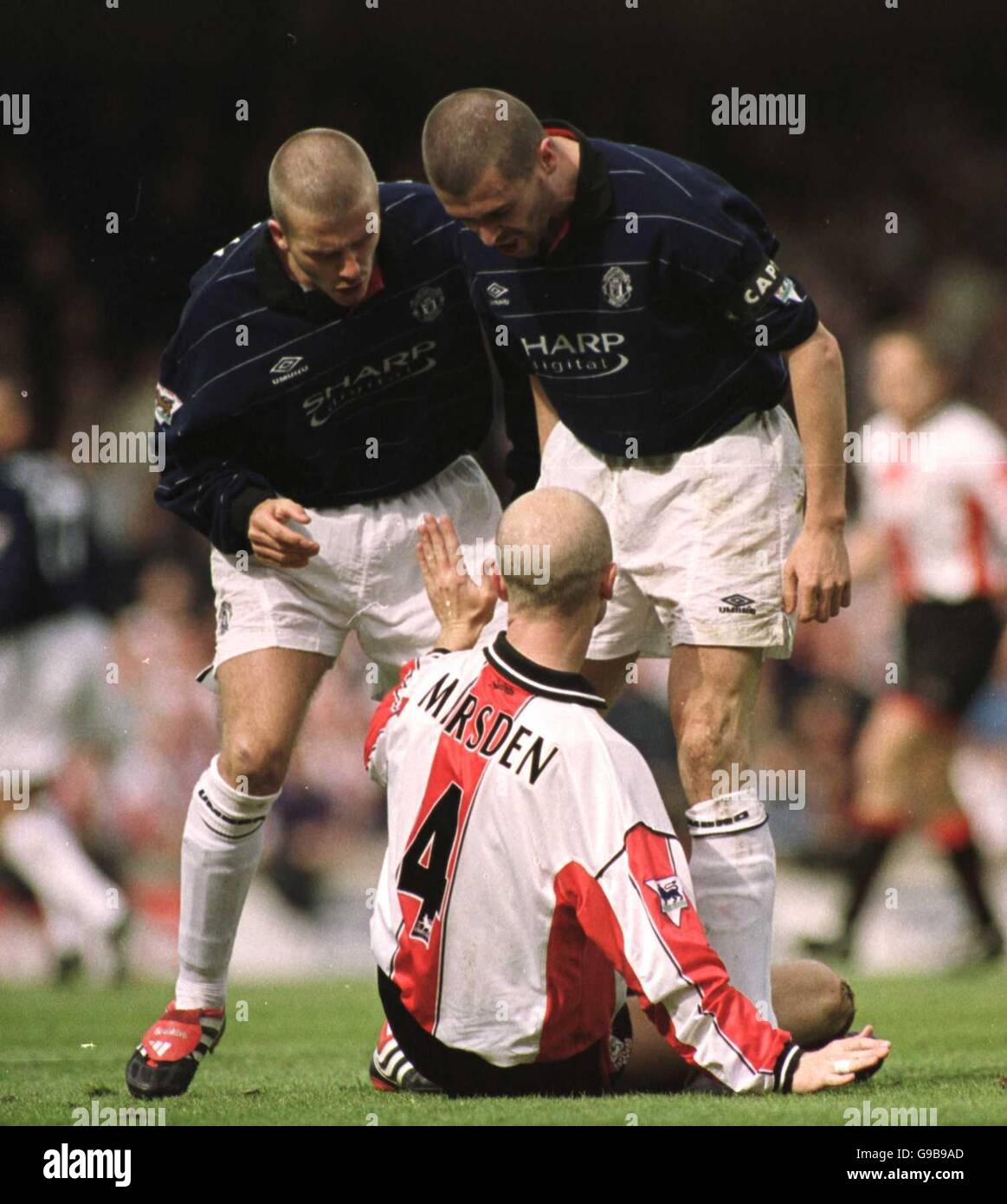 Southampton's Chris Marsden holds off Manchester United's captain Roy Keane & David Beckham after Marsden fouled David Beckham Stock Photo