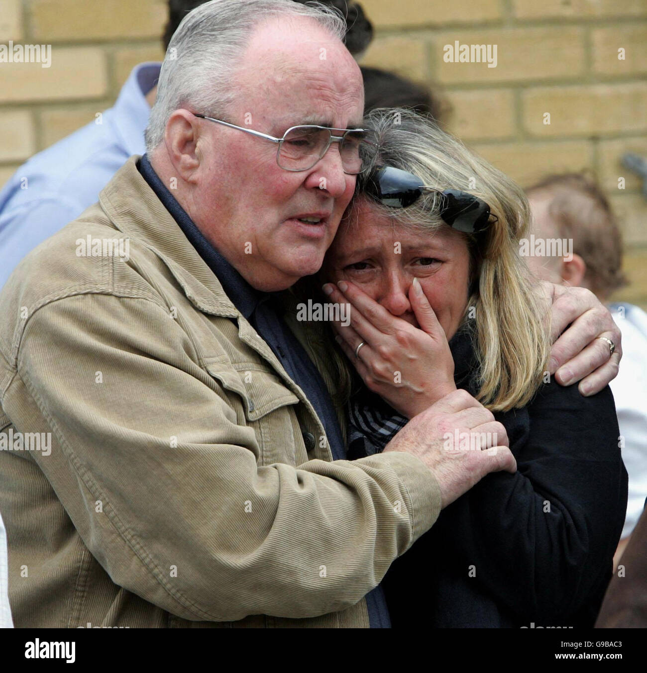 Mrs Geri Brolan, mother of journalist James Brolan, weeps with his father, Patrick, as his coffin and that of fellow journalist Paul Douglas arrive back on home soil at Heathrow after being repatriated from Iraq. The journalists were killed by a roadside bomb in Baghdad. Stock Photo