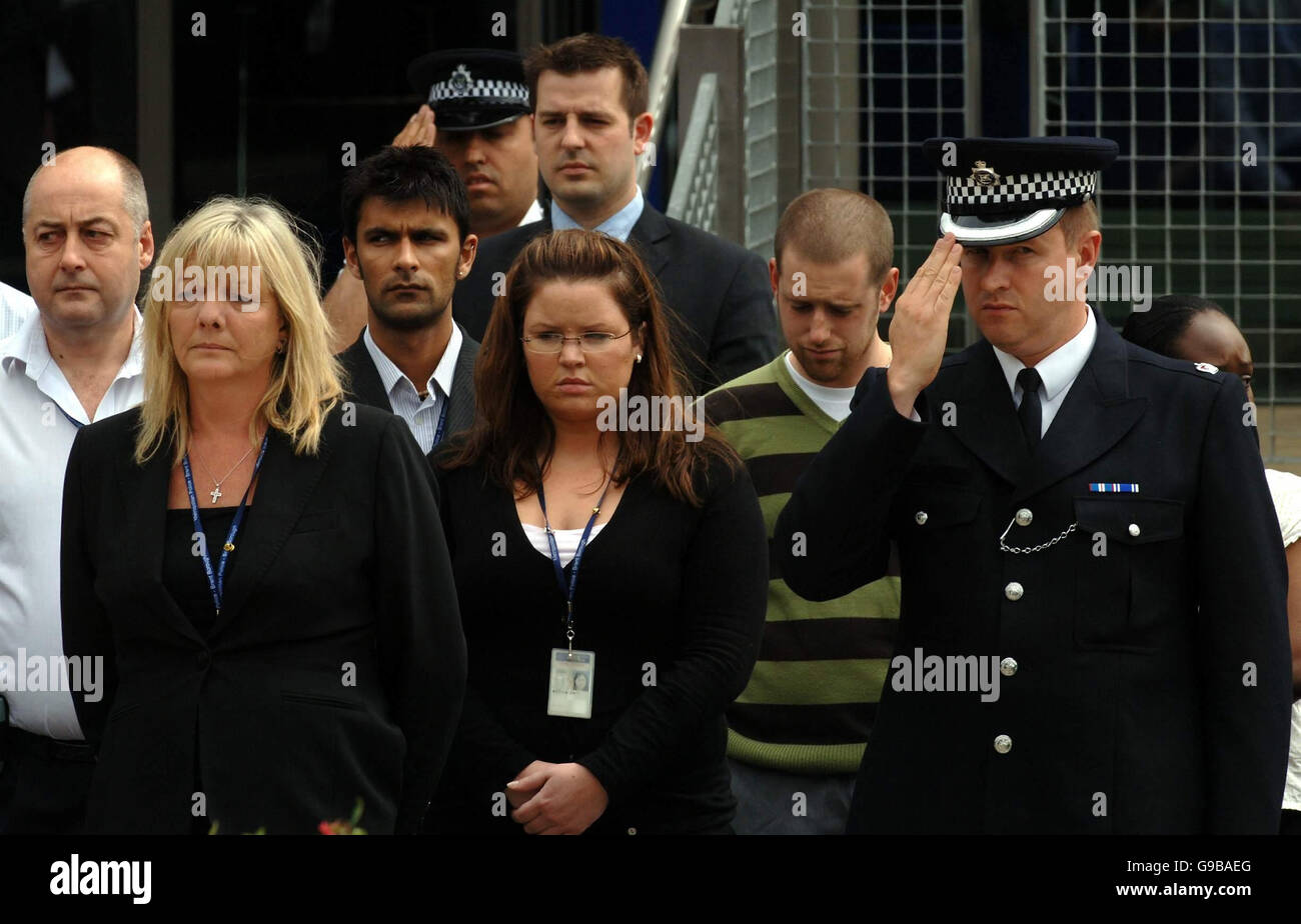 A police officer salutes the the funeral procession of murdered Special