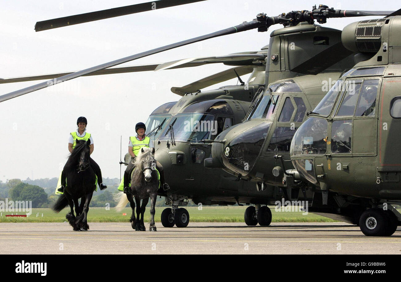 Alison Edwards (left) and Ginny Duncan, both from Wallingford, Oxon, ride 'Ted' and 'Toby' respectively during a joint launch by the MoD and the British Horse Society of high visability clothing for horses and riders in an effort to make them seen by low flying helicopters, at RAF Benson, Oxfordshire. Stock Photo
