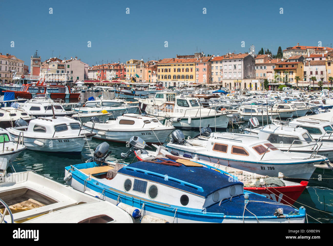 The pretty harbour town of Rovinj, or Rovigno, on the Adriatic Sea in Croatia, showing the harbour, moored boats and colourful Stock Photo