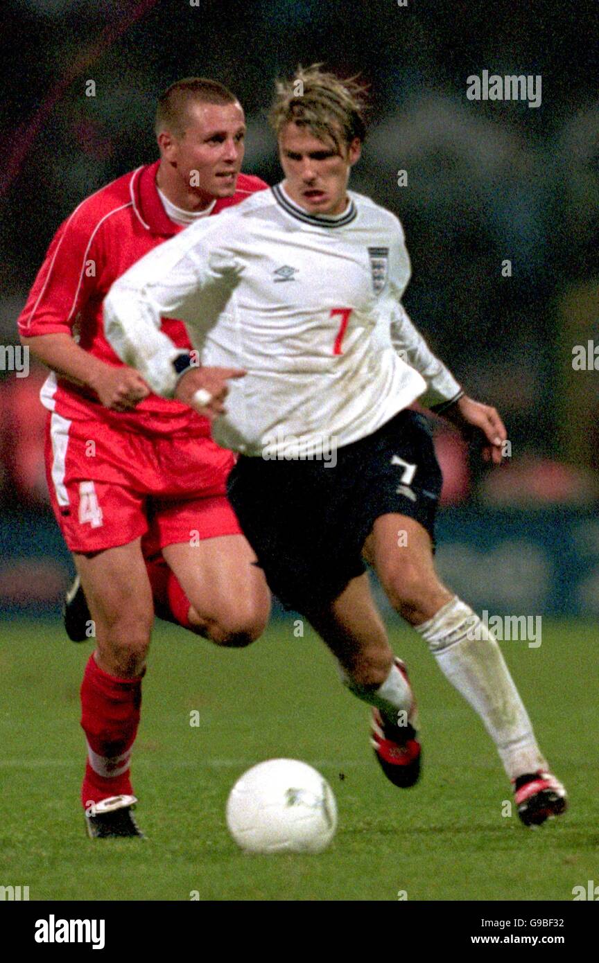 Soccer - Euro 2000 Qualifier - Group Five - Poland v England. England's David Beckham (r) gets away from Poland's Rafal Siadaczka (l) Stock Photo