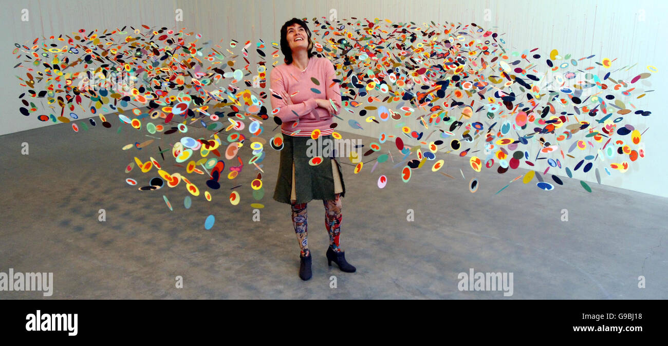 Katie Dance enjoys a work by Los Angeles artist Pae White entitled 'Morceau Arrochant' now exhibiting at the Tate Modern in London, which has rehung and reinterpreted its 'Tate Modern Collection'. Stock Photo