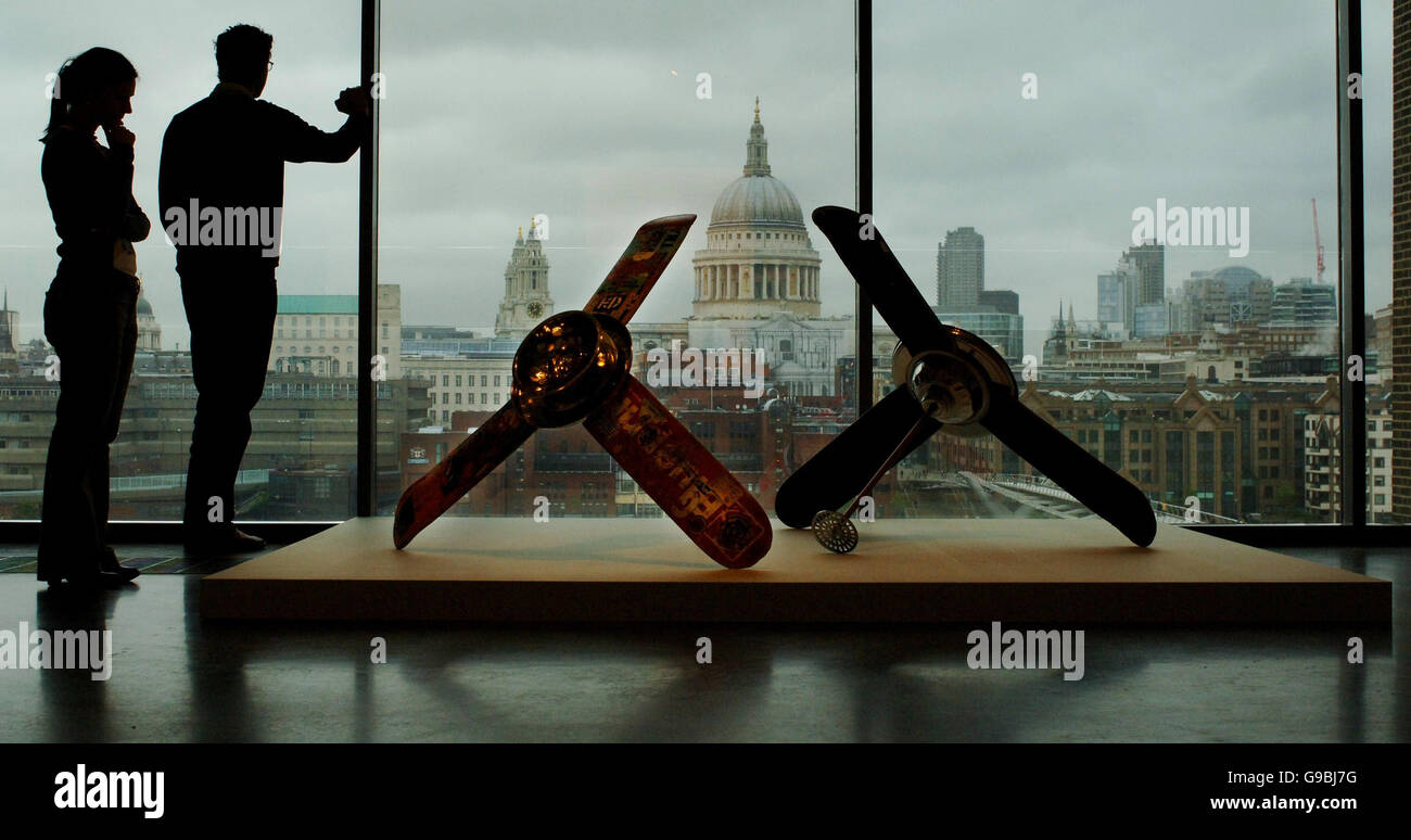 A 1969 work by Alexandre Da Cunha of two fans, titled Skateboarderistismatrnics (L) and Erik Ellington (R) is viewed by visitors at the Tate Modern in London, which has rehung and reinterpreted its 'Tate Modern Collection'. Stock Photo