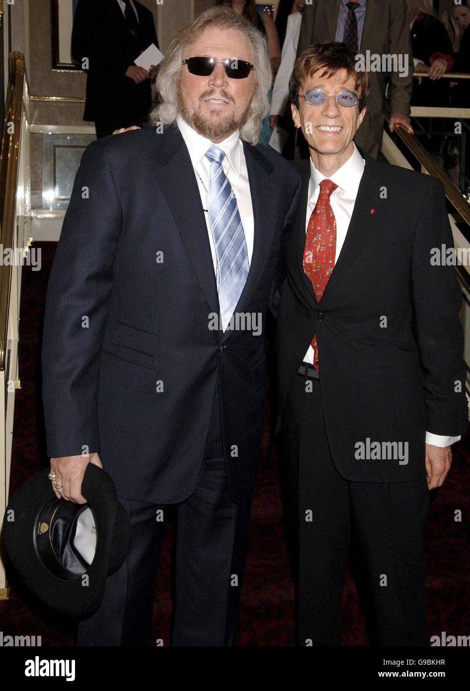 Barry Gibb (left) and Robin Gibb of the Bee Gees arrive for the 51st Ivor Novello Awards, at the Grosvenor Hotel, central London. Stock Photo