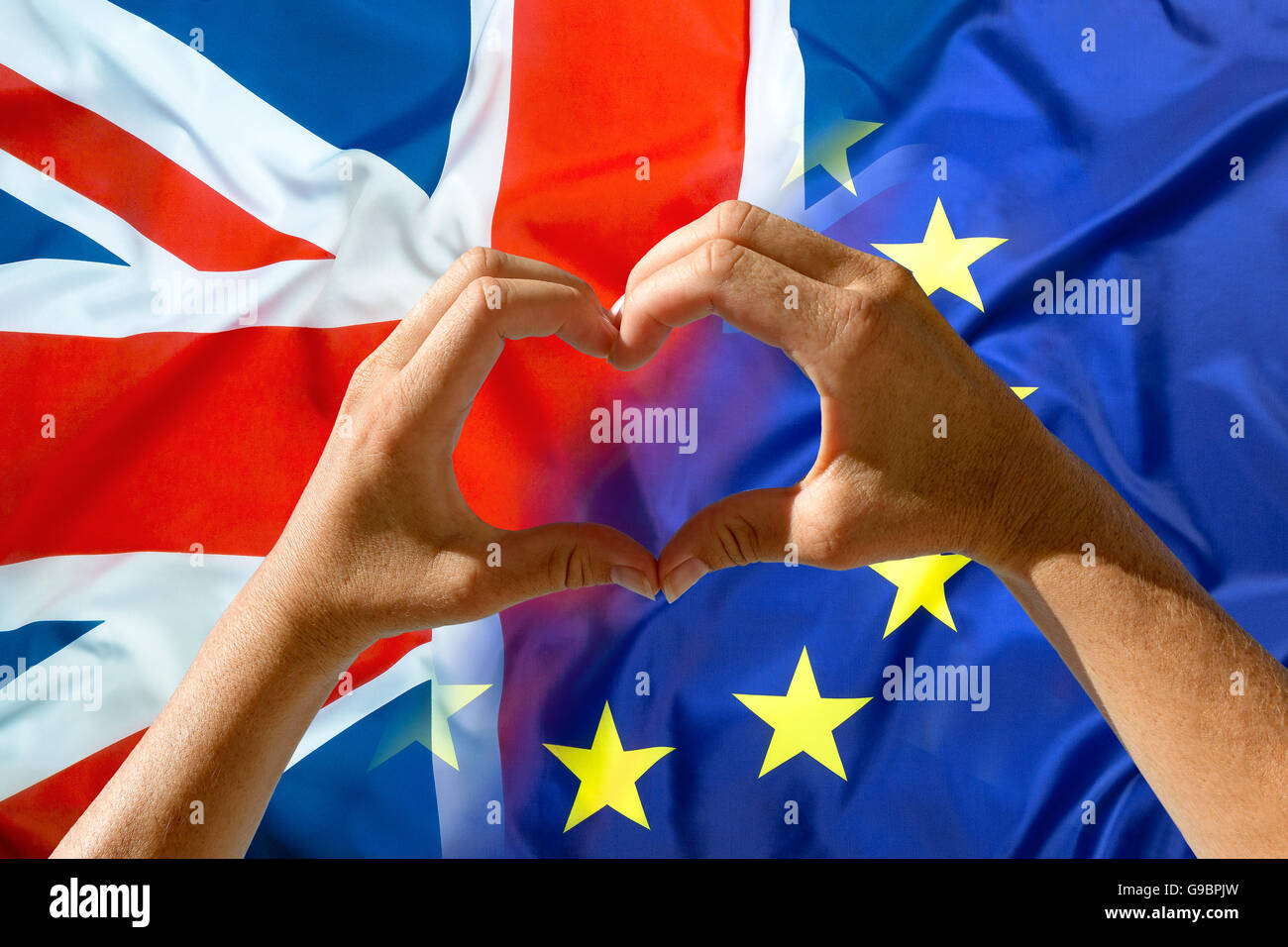 Hands heart symbol, exit Great Britain from European Union flags in background Stock Photo