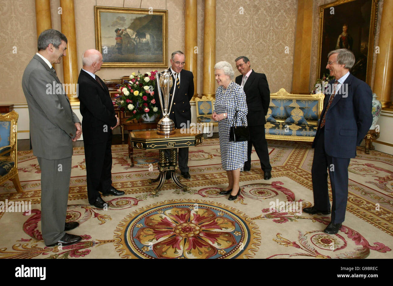Britain's Queen Elizabeth II greets a delegation from Henley Royal Regatta, at Buckingham Palace, in central London. The delegation, led by Sir Richard Sykes (far right), was presented with The Prince Albert Challenge Cup. Stock Photo
