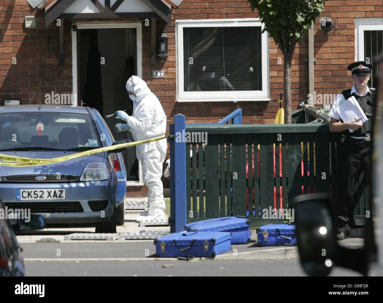 Police at the scene in the Lower Broughton area of Salford where a A 15-year-old girl and 18-year-old boy have been shot dead. Stock Photo