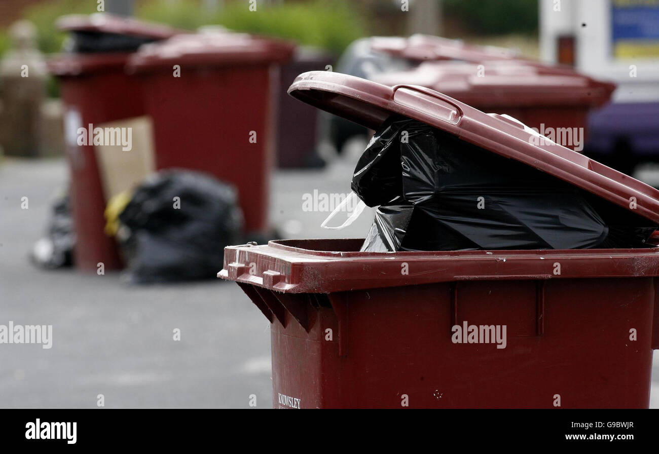 Full bins awaiting rubbish collection on Halewood Road in Knowsley