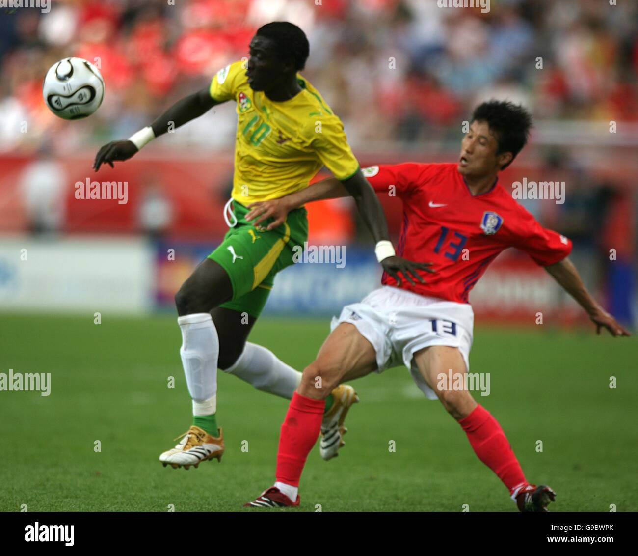 Eul-Yong Lee of South Korea and Mamam Cherif-Toure of Togo battle for the ball Stock Photo