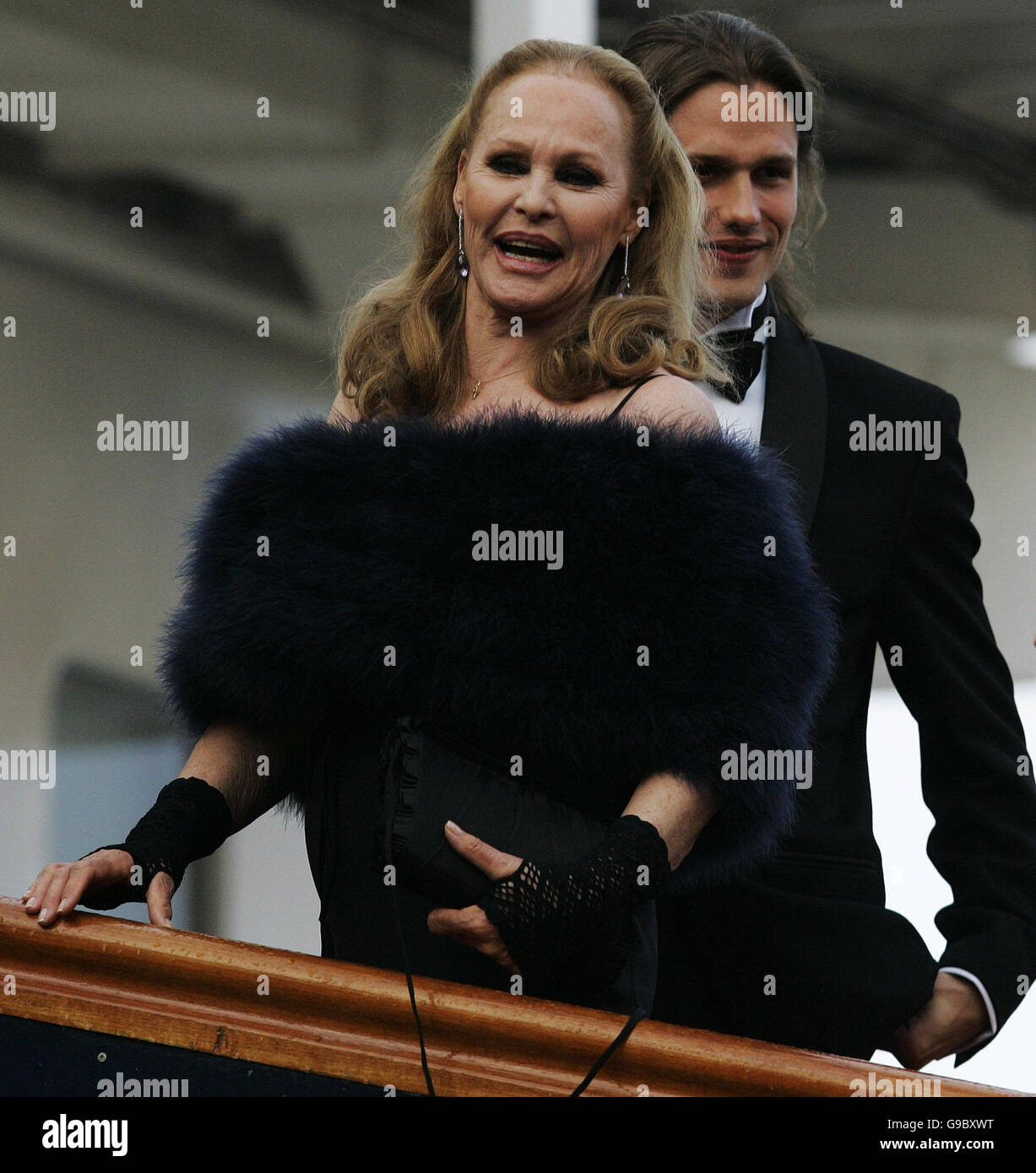 Ursula Andress is helped from car from son Dimitri Hamlin after arriving in the original James Bond Aston Martin DB5 from 'Goldfinger' at the Royal Yacht Britannia in Edinburgh to celebrate her Birthday. The occasion also marks the opneing of the Swiss Consulate General in Edinburgh. Thursday 18th May 2006. PA Andrew Milligan Stock Photo