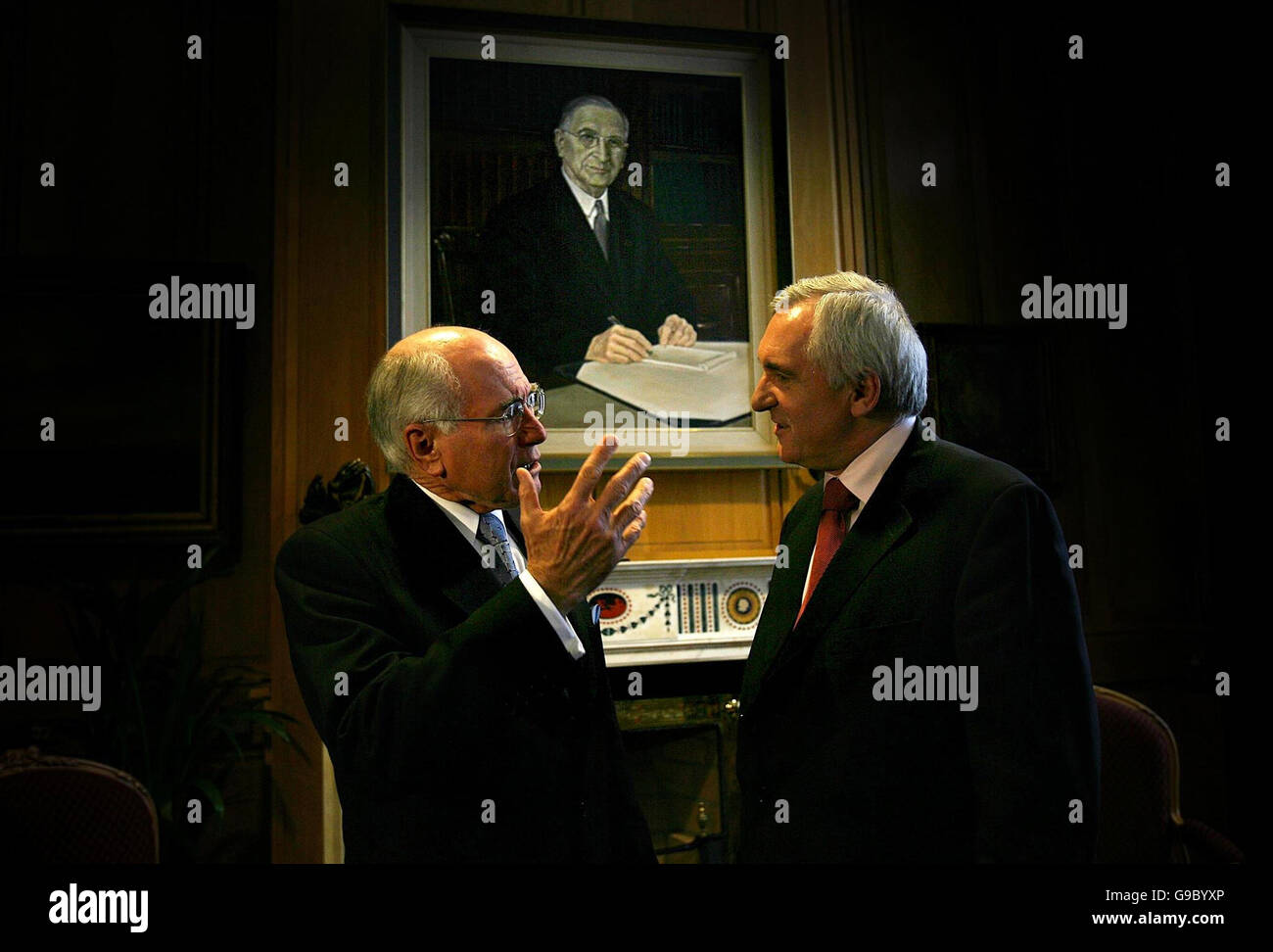Taoiseach Bertie Ahern meets Australian Prime Minister John Howard (left) in his office at Government Buildings under the watchful gaze of Eamon De Valera. Stock Photo