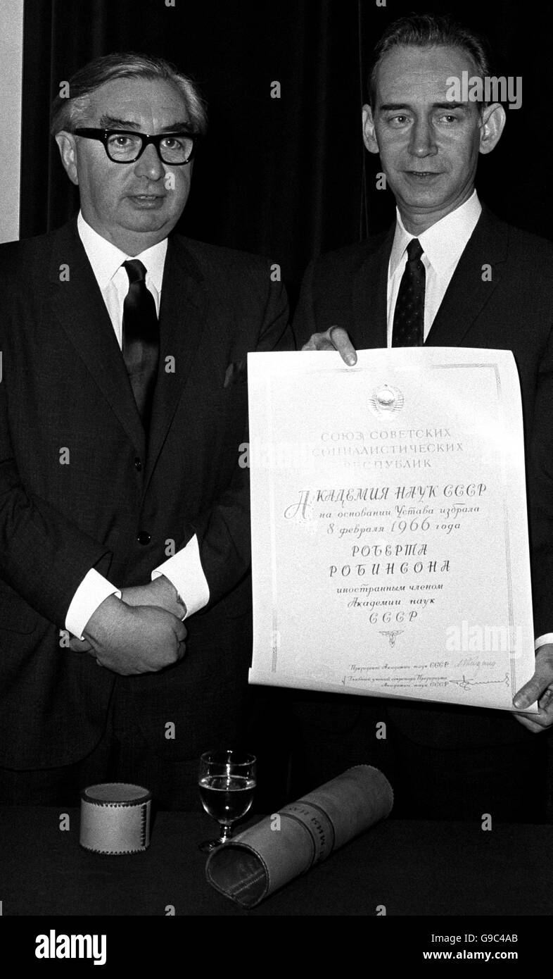 Mr Mikhail N. Smirnovsky, the Soviet Ambassador, displays the scroll of membership of the Soviet Academy. Mr George Brown stands beside him. Stock Photo