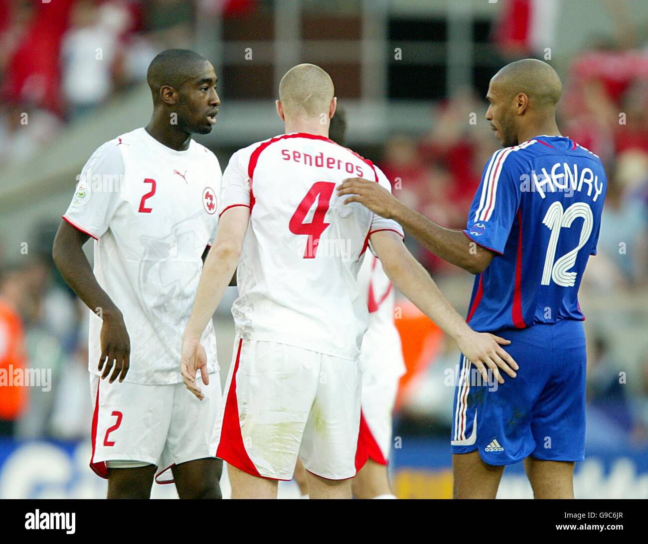 Soccer - 2006 FIFA World Cup Germany - Group G - France v Switzerland - Gottlieb-Daimler-Stadion. Switzerland's Philippe Senderos and Johan Djourou with Arsenal team mate Thierry Henry at the final whistle Stock Photo