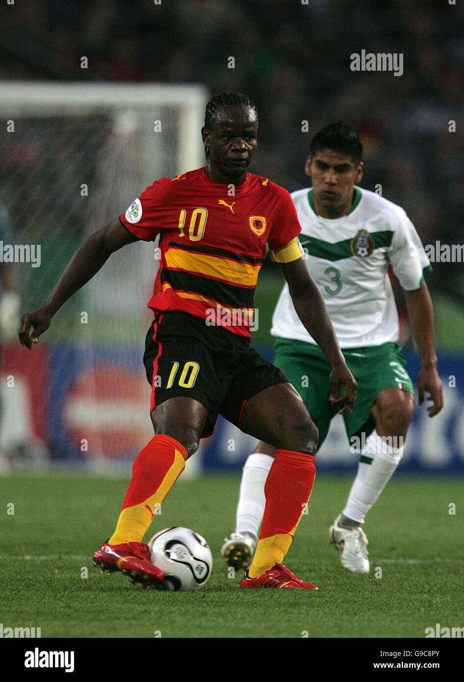 Soccer - 2006 FIFA World Cup Germany - Group D - Mexico v Angola - AWD Arena. Carlos Salcido, Mexico and Fabrice Akwa, Angola battle for the ball Stock Photo