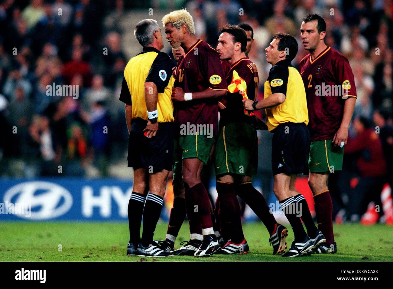 (L-R) Referee Gunter Benko is approached by Portugal's Abel Xavier, Paulo Bento and Jorge Costa after he awarded the red card to Nuno Gomes Stock Photo