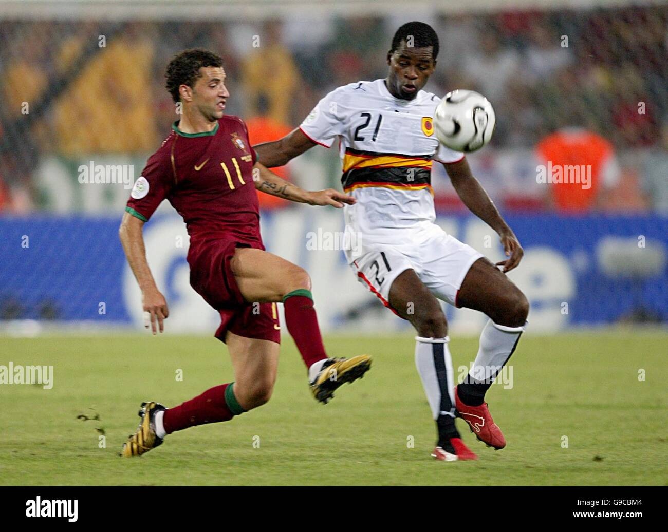 Soccer - 2006 FIFA World Cup Germany - Group D - Angola v Portugal - RheinEnergieStadion. Angola's Luis Delgado and Portugal's Sabrosa Simao Stock Photo