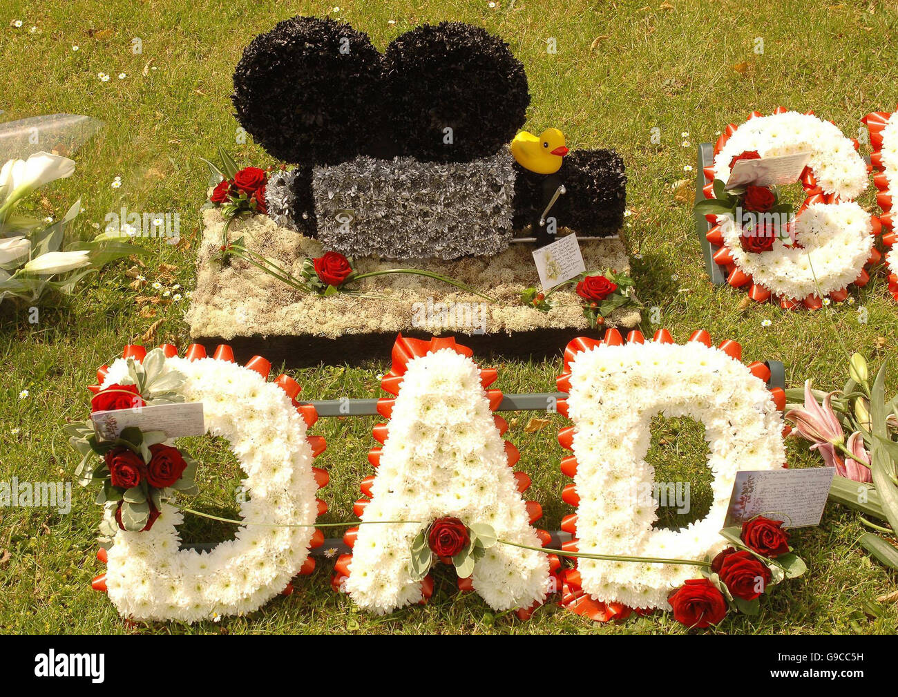 Floral tributes lie outside the Crematorium Chapel in Bedford where the