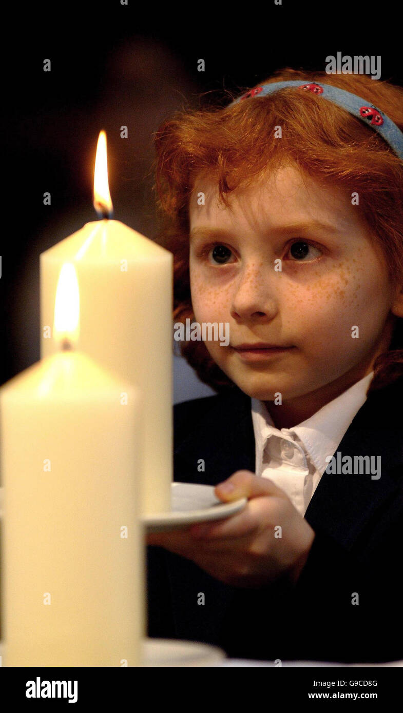 Lydia Ballam lights candles to remember the IRA Manchester bomb blast which happened ten years ago today. Stock Photo