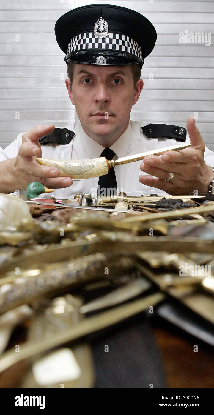 Lothian and Borders Police Constable Stephen McGill from the Safer Communities Department displays a collection of about 500 letter openers handed in by one gentleman during the National Knives Amnesty which runs until the end of June. Stock Photo