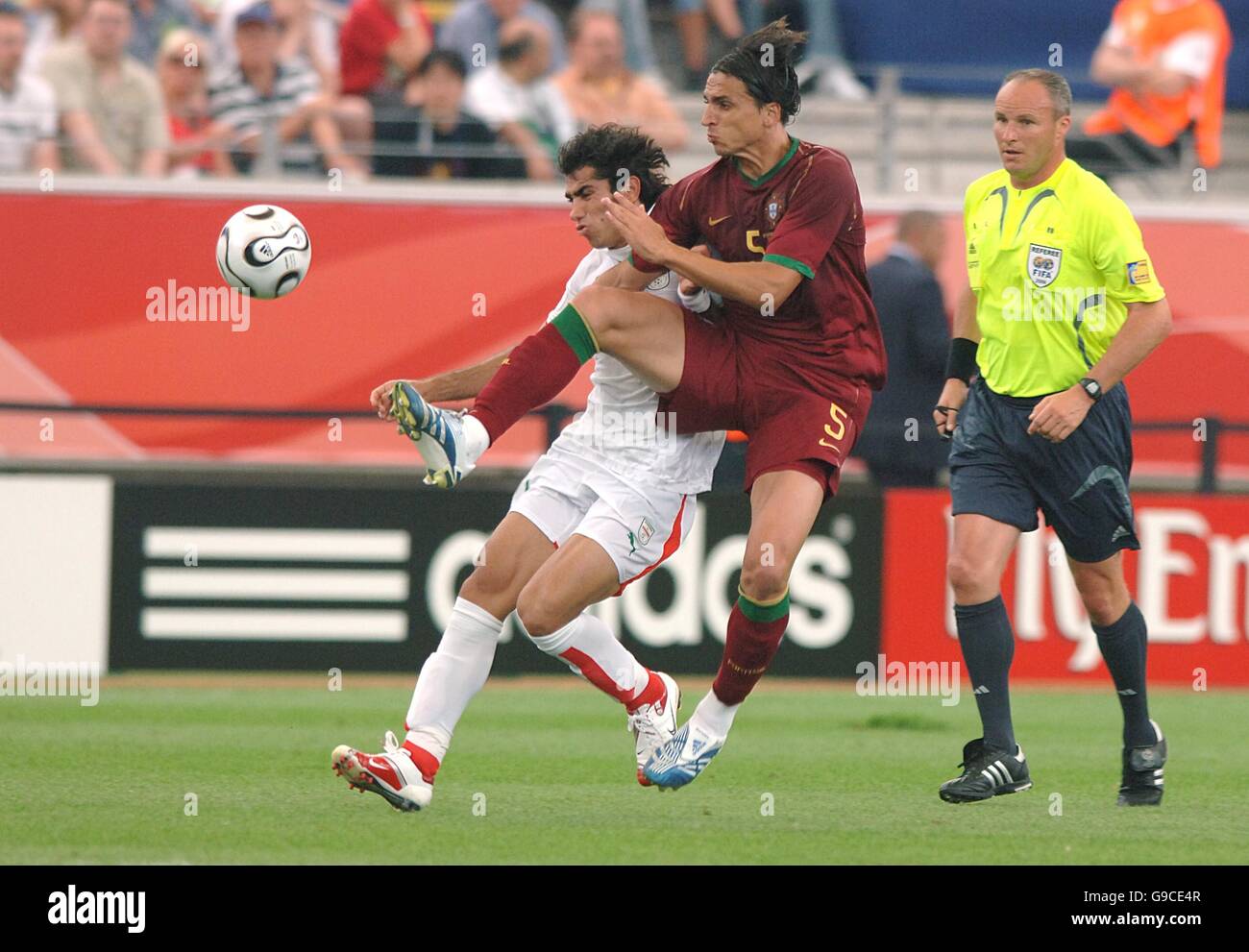 (L-R) Mehrzad Madanchi, Iran and Fernando Meira, Portugal battle for the ball Stock Photo