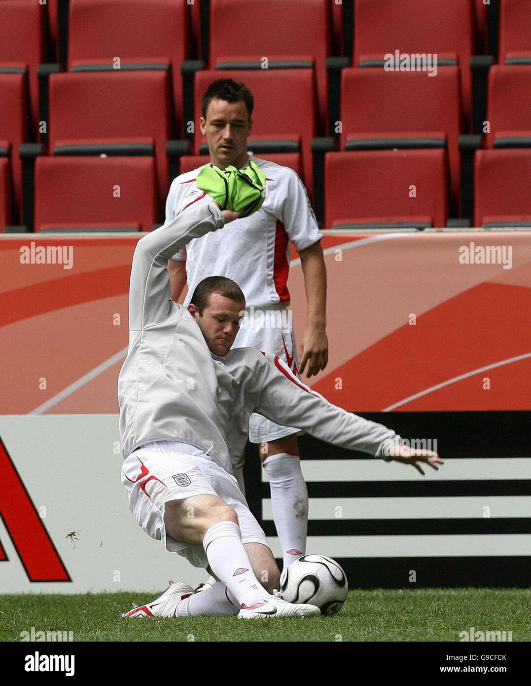 England's John Terry (back) watches Wayne Rooney during a training session at FIFA World Cup Stadium, Cologne, Germany. Stock Photo