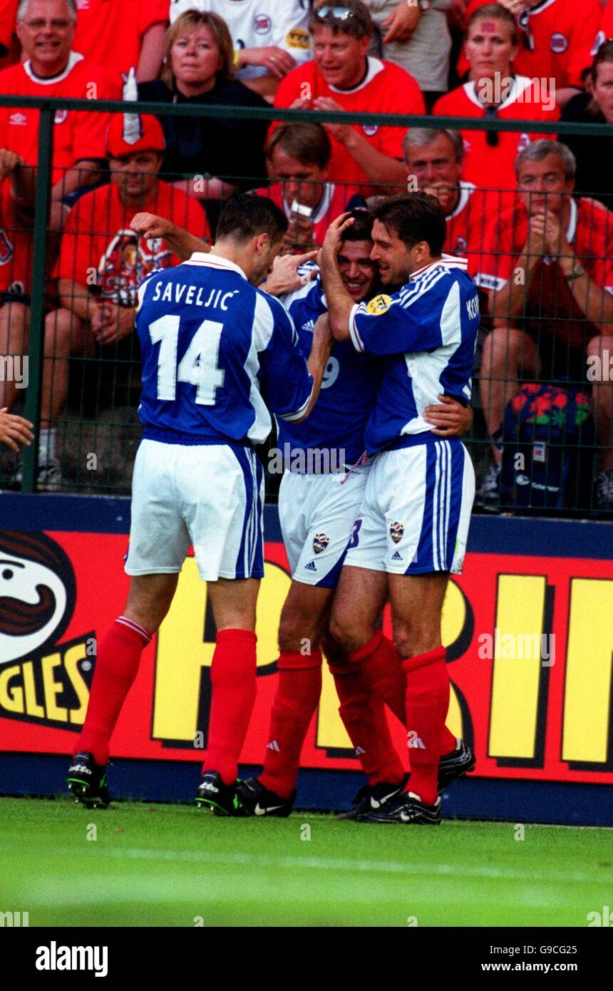 Yugoslavia's Nisa Saveljic (L) and Slobodan Komljenovic (R) congratulate Savo Milosevic on scoring the first goal of today's game Stock Photo