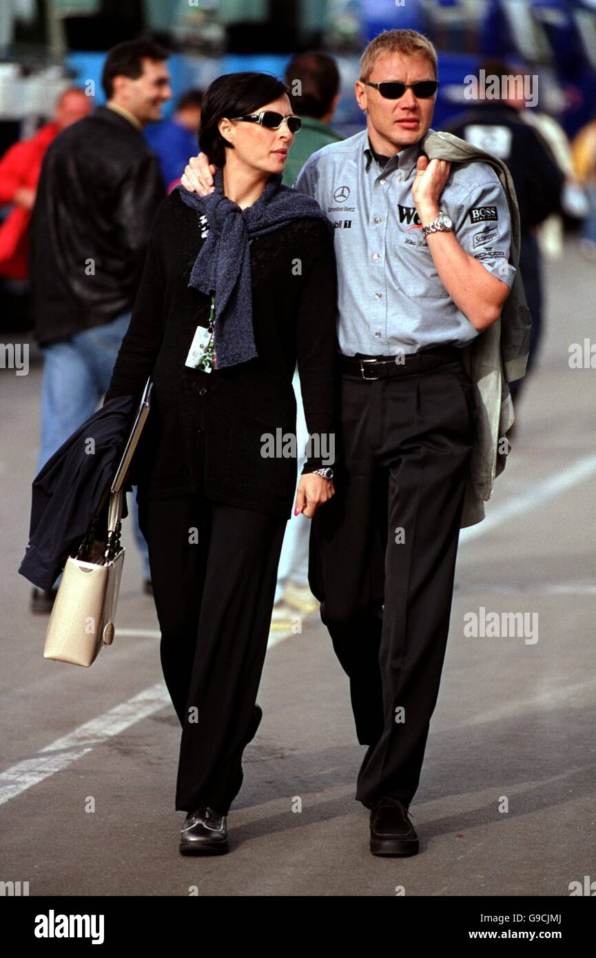 Race winner Mika Hakkinen walks through the paddock with wife Erja