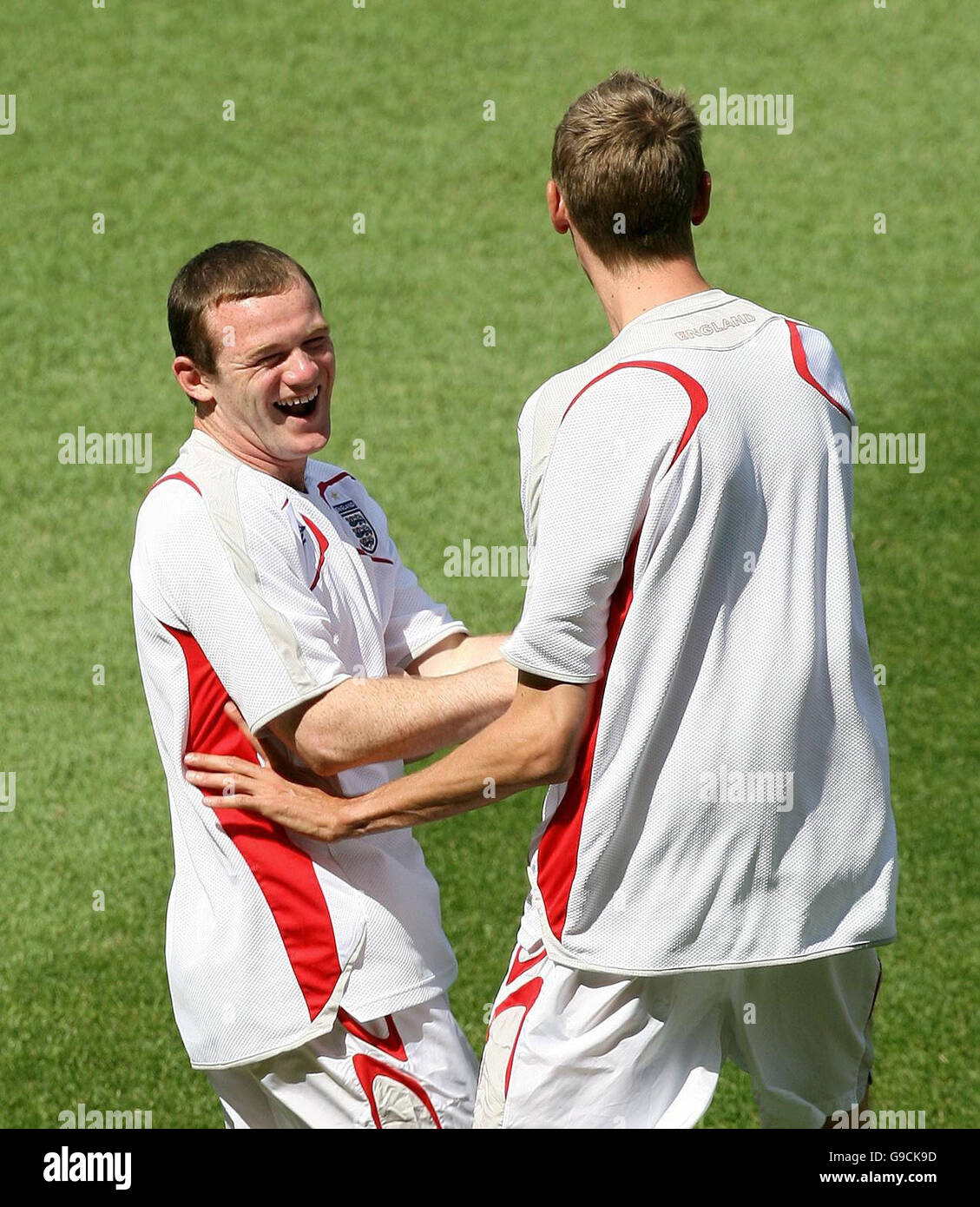 England's Wayne Rooney (left) shares a joke with Peter Crouch during a training session at the Gottlieb Daimler Stadion, Stuttgart, Germany. Stock Photo