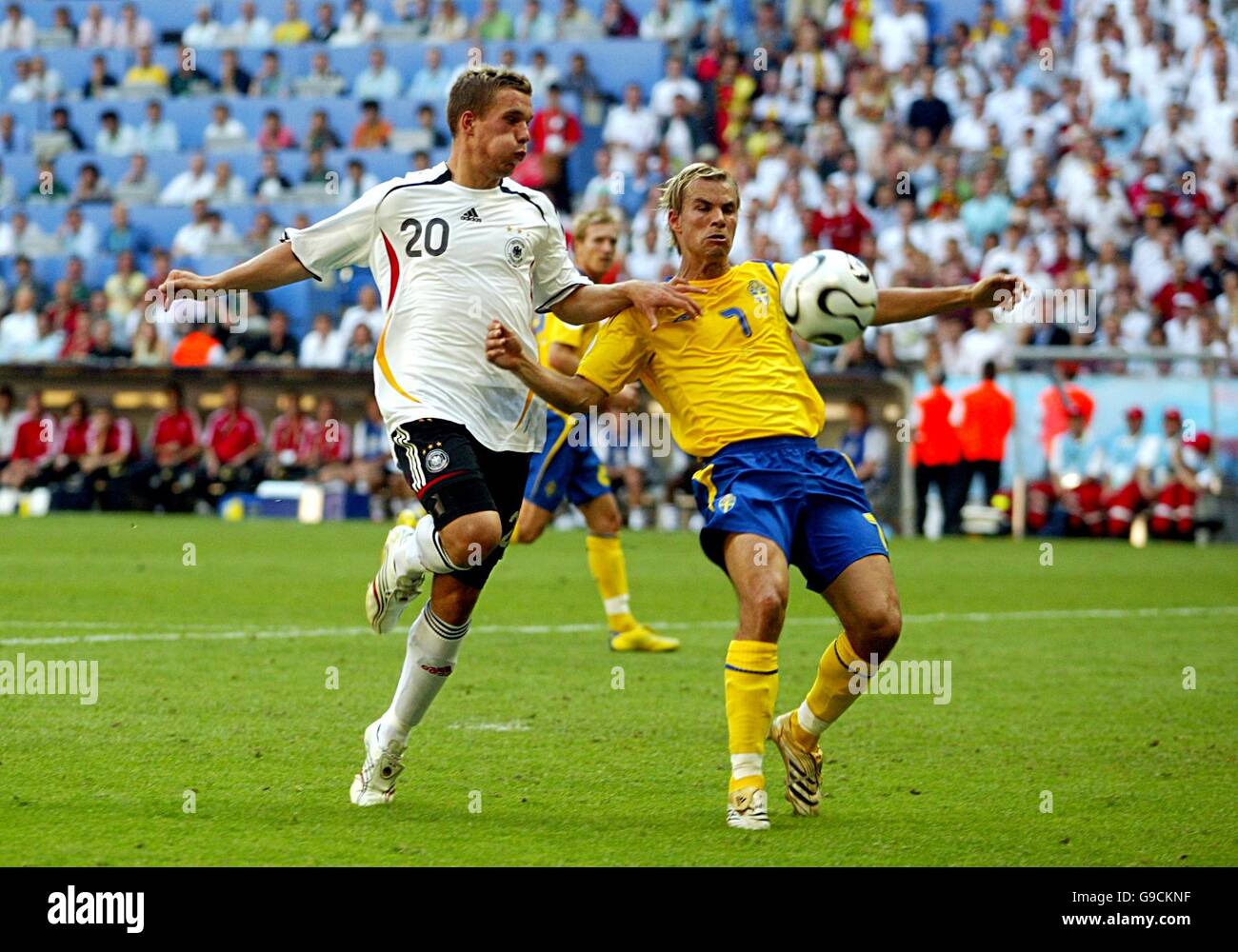 Soccer - 2006 FIFA World Cup Germany - Second Round - Germany v Sweden - Allianz Arena. Germany's Lukas Podolski (l) and Sweden's Niclas Alexandersson battle for the ball Stock Photo