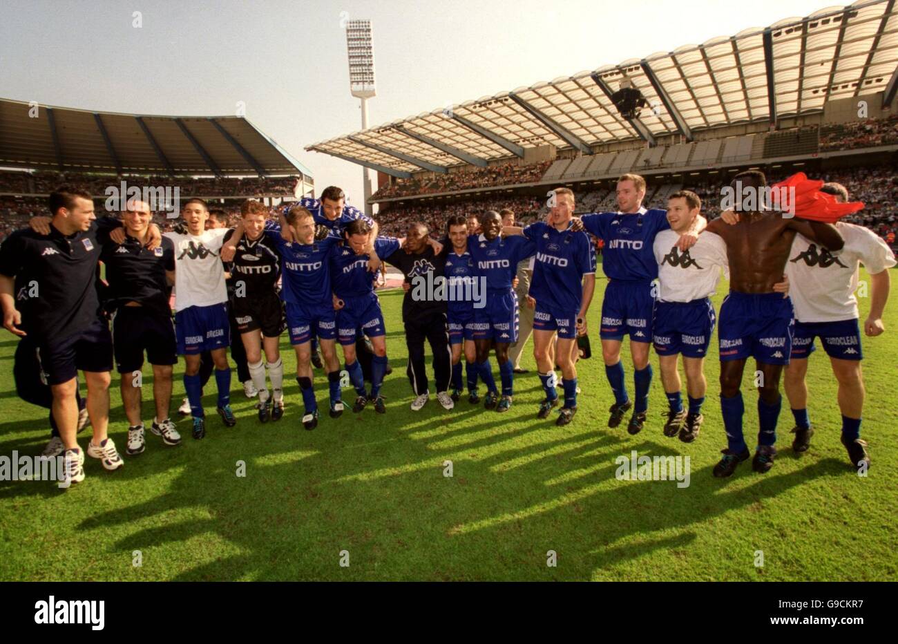 Team group arms around shoulders celebration bouncing jumping football hires stock photography