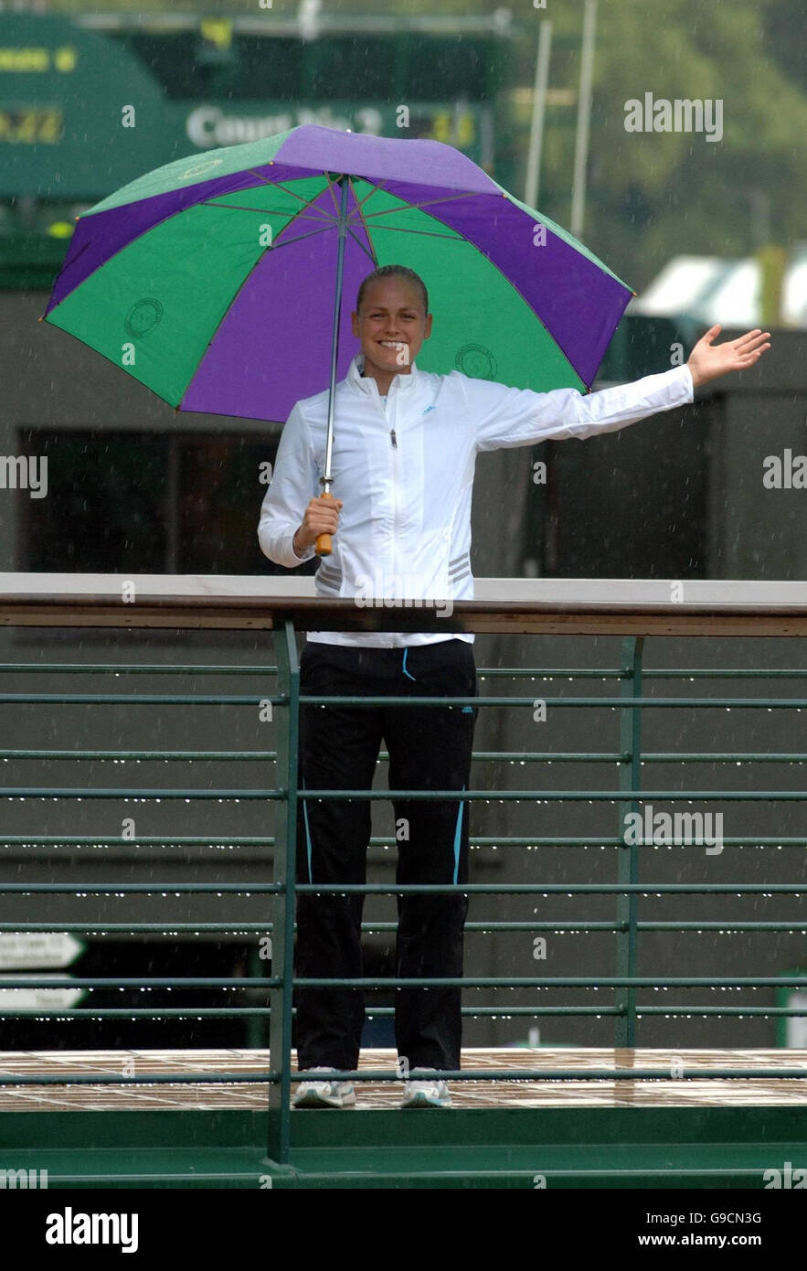Germany's Anna-Lena Groenefeld shelters from the rain during a photo call on the first day of the wimbledon Championships. Stock Photo