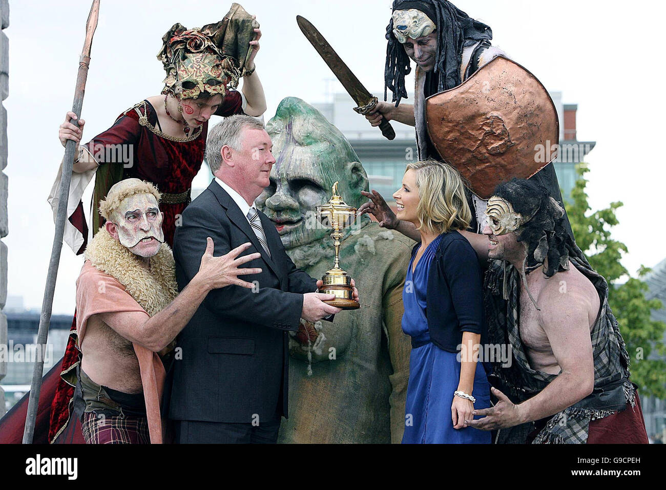 Sports minister John O'Donoghue TD holds up the Ryder Cup with Galway performers Macteo and TV presenter Sharon Ni Bheolain at the launch in Dublin's Docklands for the official programme of events for the three-day contest between Europe and America at the K Club in Kildare. Stock Photo