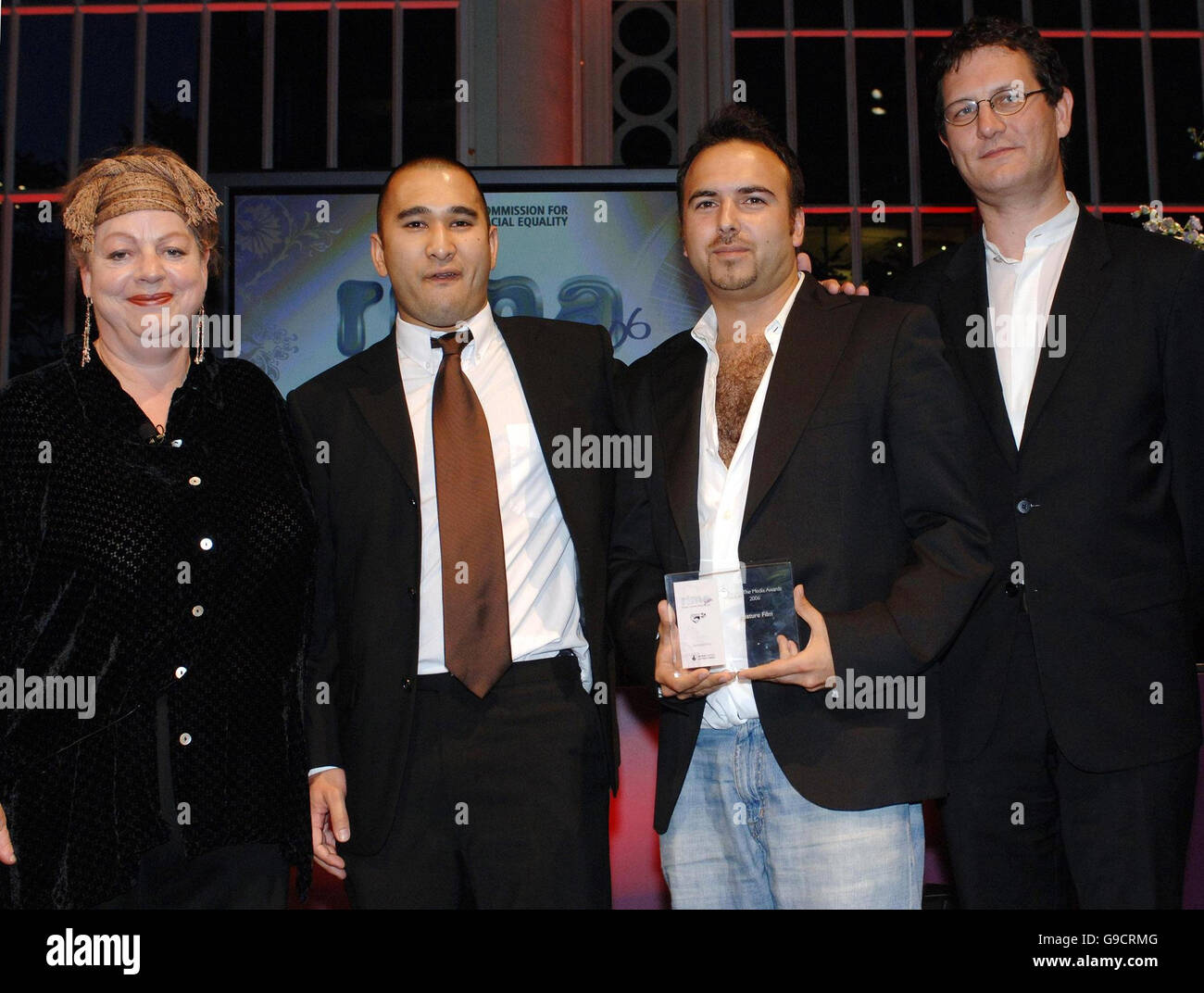 Justin Marciano, second right, and Tom Clark, second left, collects the Feature Film award for Kidulthood, from John Woodward accompanied by comedienne and ceremony presenter Jo Brand, at the Commission for Racial Equality's Race In The Media Awards 2006 at London's Royal Opera House. Stock Photo