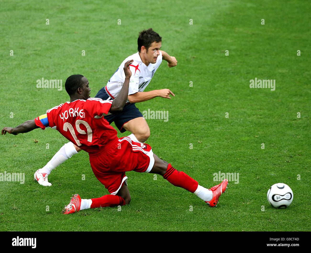(L-R) Dwight Yorke, Trinidad and Tobago and Joe Cole, England battle for the ball Stock Photo
