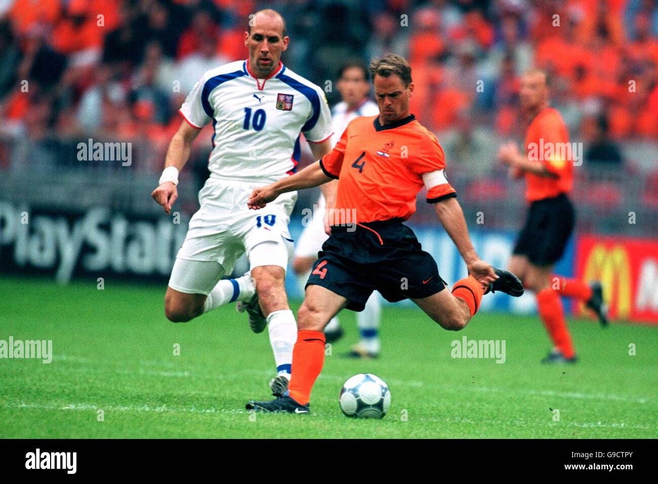 Czech Republic's Jan Koller (l) watches Holland's Frank De Boer (r) launch the ball forwards Stock Photo