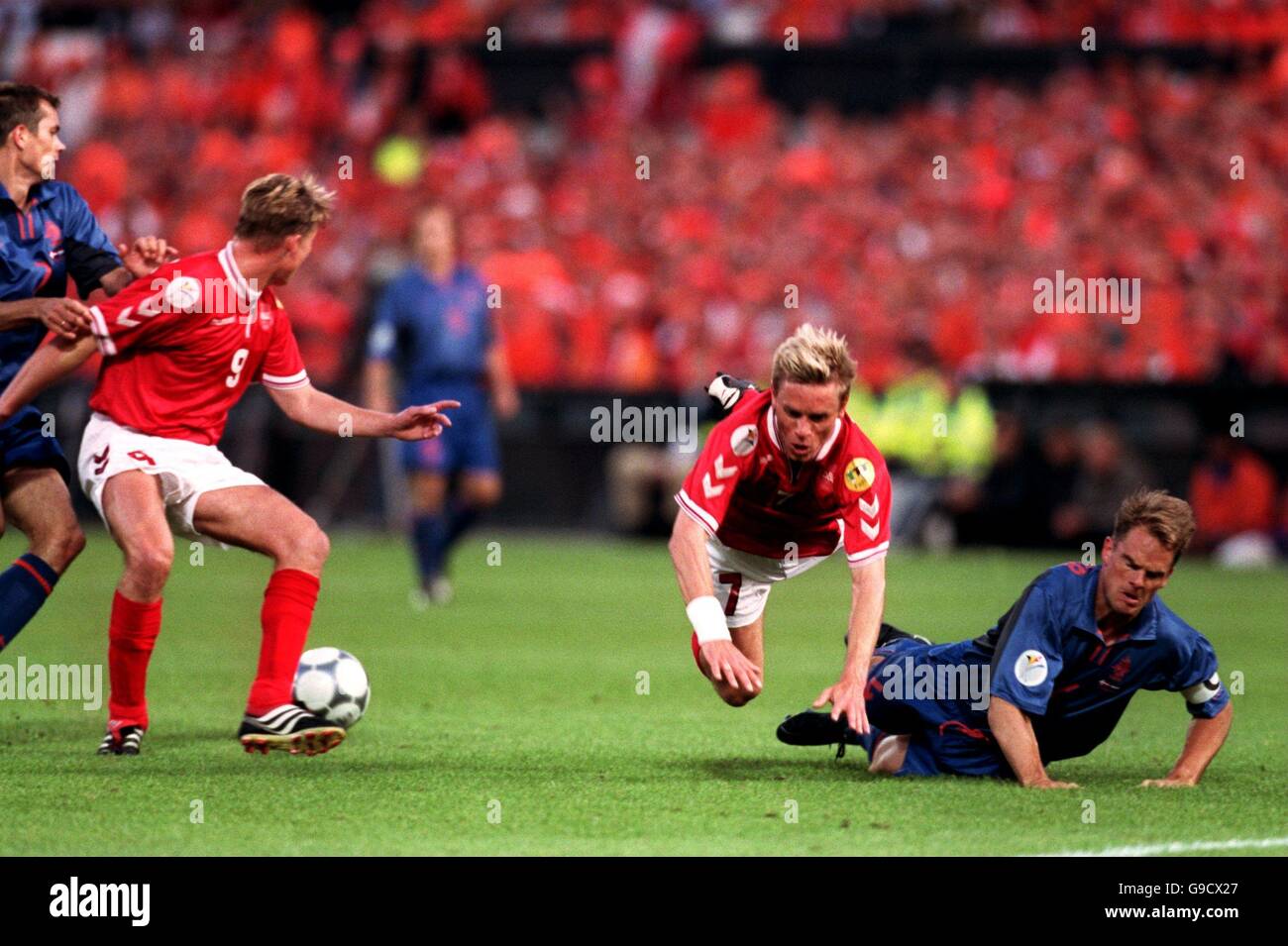 (L-R) Denmark's Allan Nielsen is tackled by Holland's Frank De Boer Stock Photo