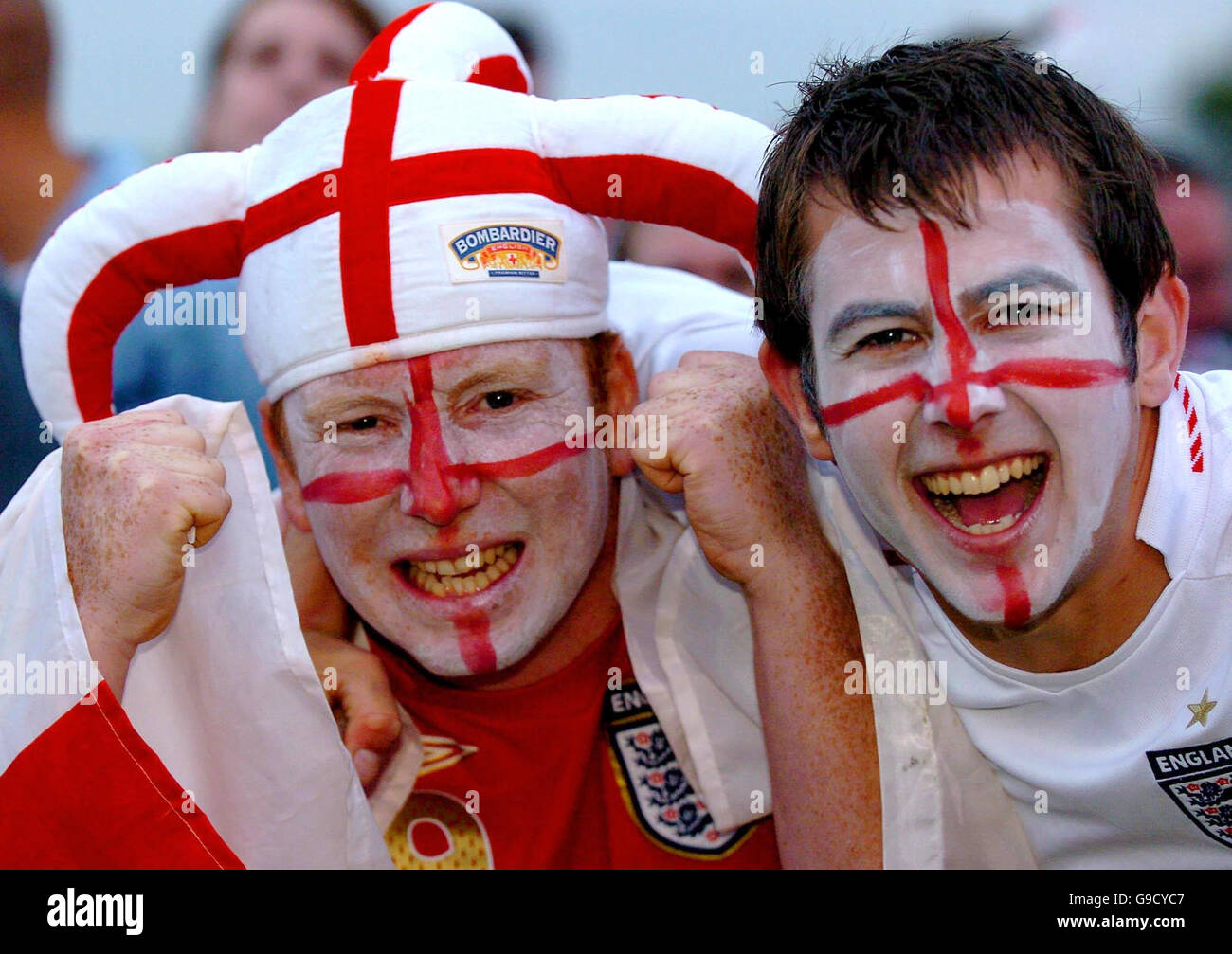 England Fans Lee Hill (left) and Graeme Jarvis, celebrate whilst watching a big screen on Parkers Piece Cambridge, after Joe Cole scored for England during their FIFA World Cup Group B Match against Sweden. Stock Photo