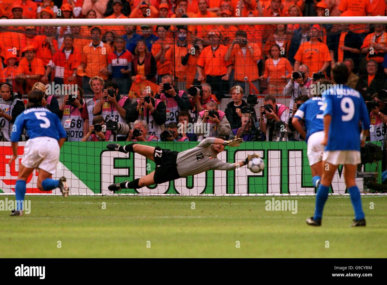 Italy goalkeeper Francesco Toldo dives to his left to save Holland's first penalty of the match Stock Photo