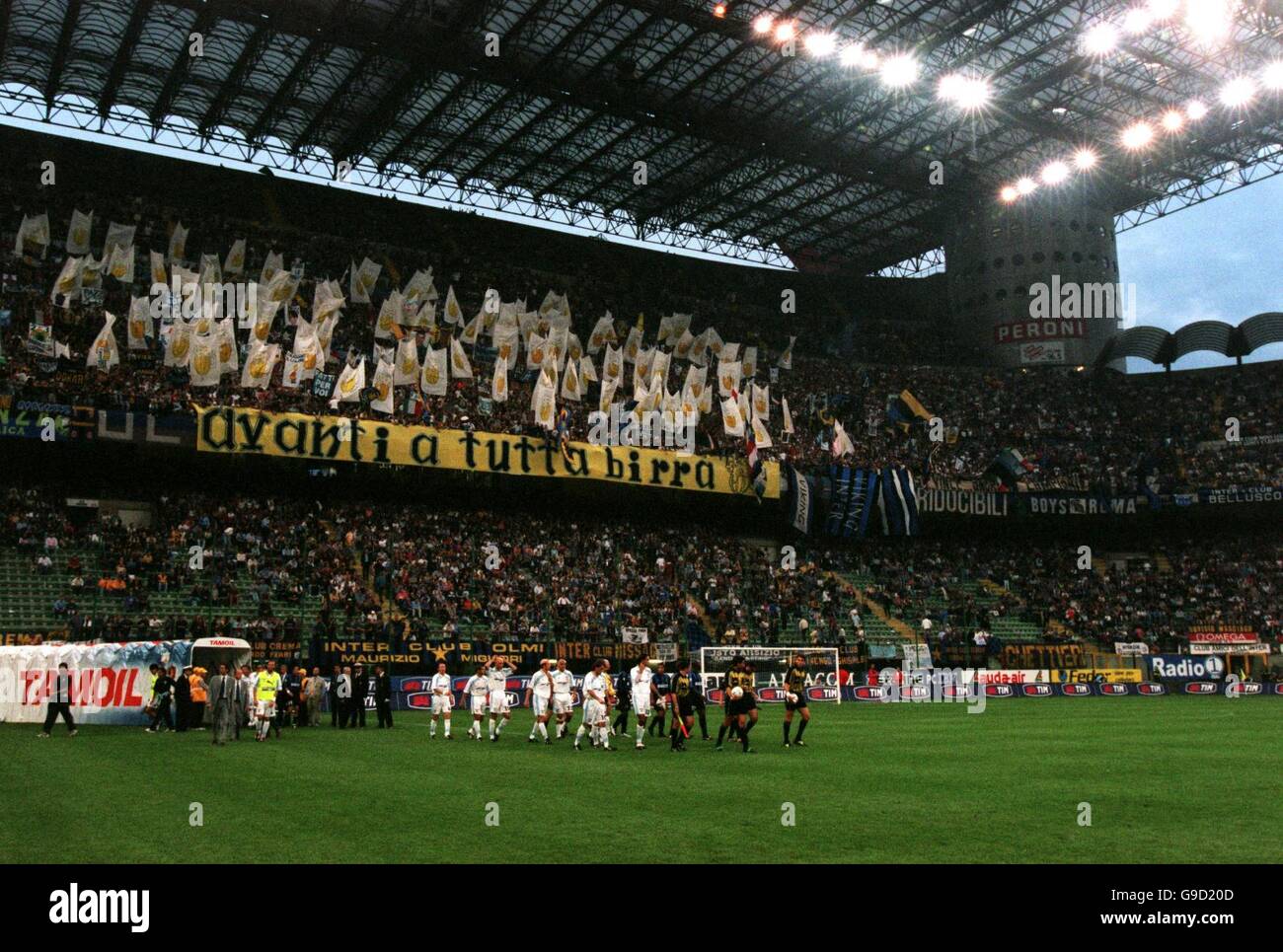 Italian Soccer - Coppa Italia - Final Second Leg - Inter Milan v Lazio. The two teams walk out into the Stadio Giuseppe Meazza, as the Inter Milan fans behind the goal anticipate a huge celebration after the match Stock Photo