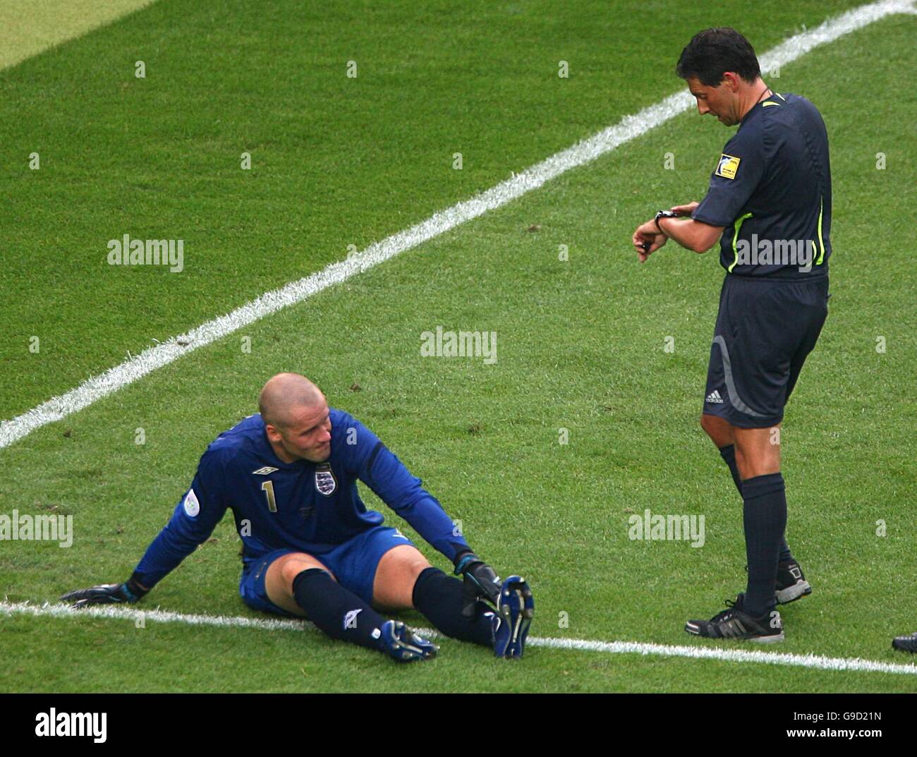 Soccer - 2006 FIFA World Cup Germany - Second Round - England v Ecuador - Gottlieb-Daimler-Stadion. Referee Frank De Bleeckere looks on as England goalkeeper Paul Robinson lies injured Stock Photo