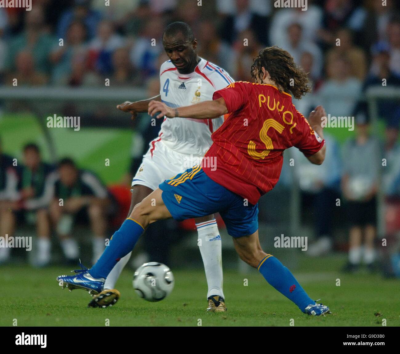 Soccer - 2006 FIFA World Cup Germany - Second Round - Spain v France - AWD Arena. Carles Puyol, Spain and Patrick Vieira, France battle for the ball Stock Photo