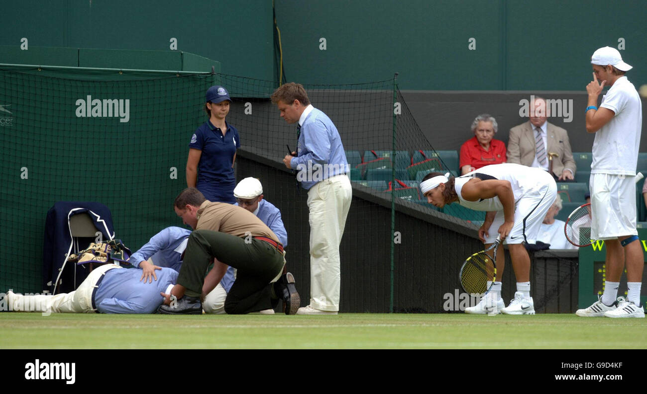 An official collapses as Spain's Rafael Nadal and USA's Robert Kendrick