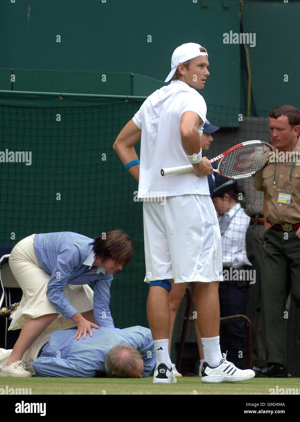 An official collapses as USA's Robert Kendrick looks on during the
